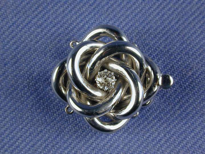Antique diamond set knot clasp, with a central diamond
